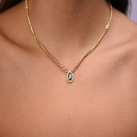 18K gold set with a green teardrop stone
