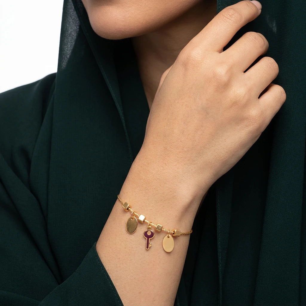 18K Gold Bracelet with Key and Dangling Charms