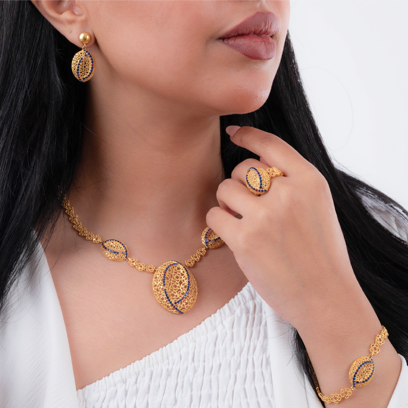 21-karat gold set studded with navy blue stones